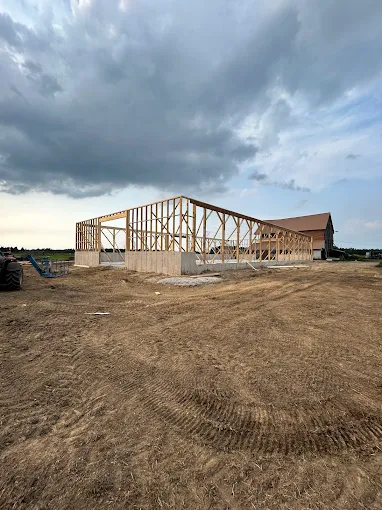 Large timber-framed agricultural building under construction