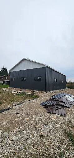 Two-tone grey post-frame building with metal siding